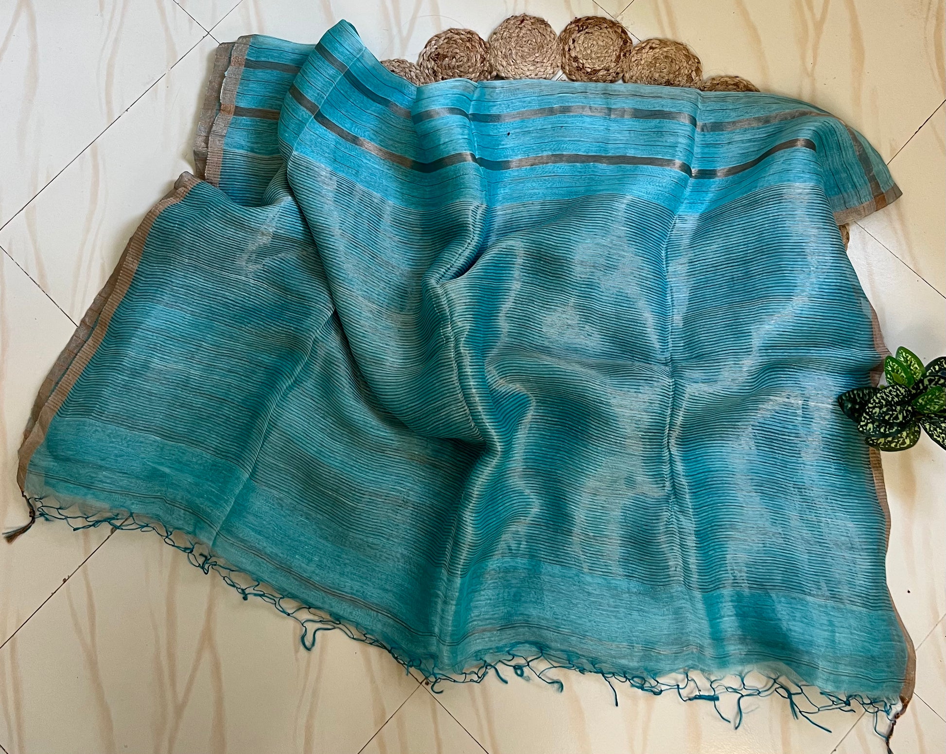 Sky blue linen silk saree pallu with tassels and zari stripes