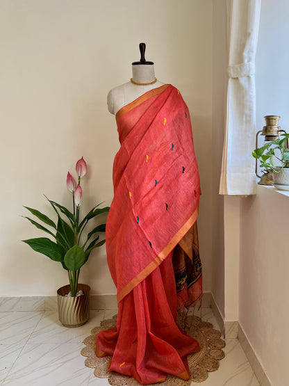 Coral red handloom linen silk saree with Paithani-style pallu draped on a mannequin