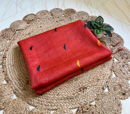 Close-up of bird motifs on coral red handloom linen silk saree