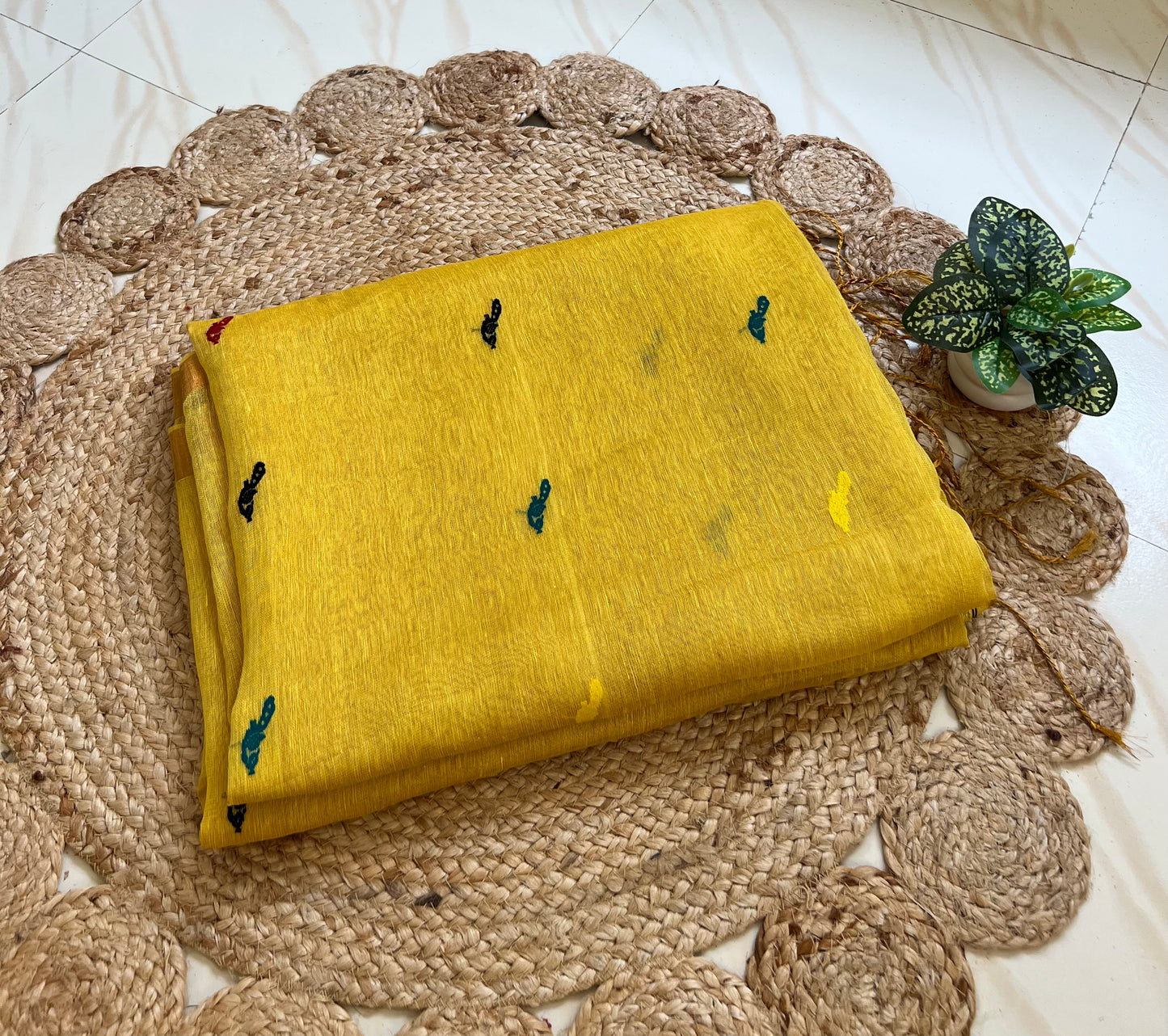 Close-up of bird motifs on yellow handloom linen silk saree