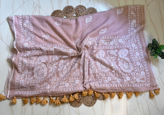 Close-up of white chikankari-style embroidered pallu border on dusty peach mul cotton saree