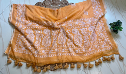 Close-up of white chikankari-style embroidered pallu border on marigold orange mul cotton saree