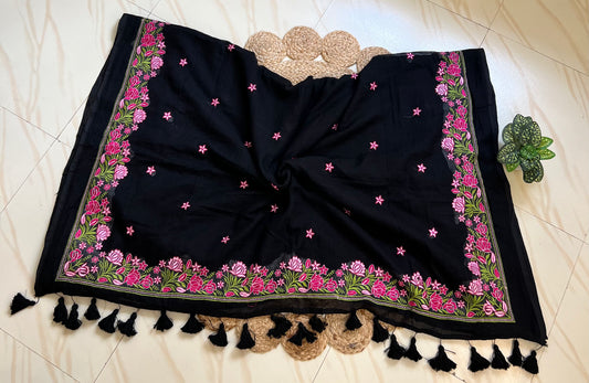 Close-up of pink floral hand-embroidered pallu on black mul cotton saree