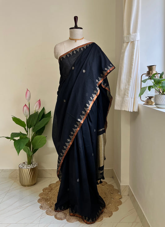 Classic black pure cotton jamdani saree with copper zari border and pallu, draped on mannequin