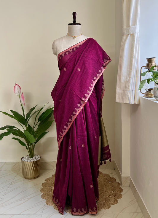 Berry wine pure cotton jamdani saree with copper zari border and pallu, draped on mannequin
